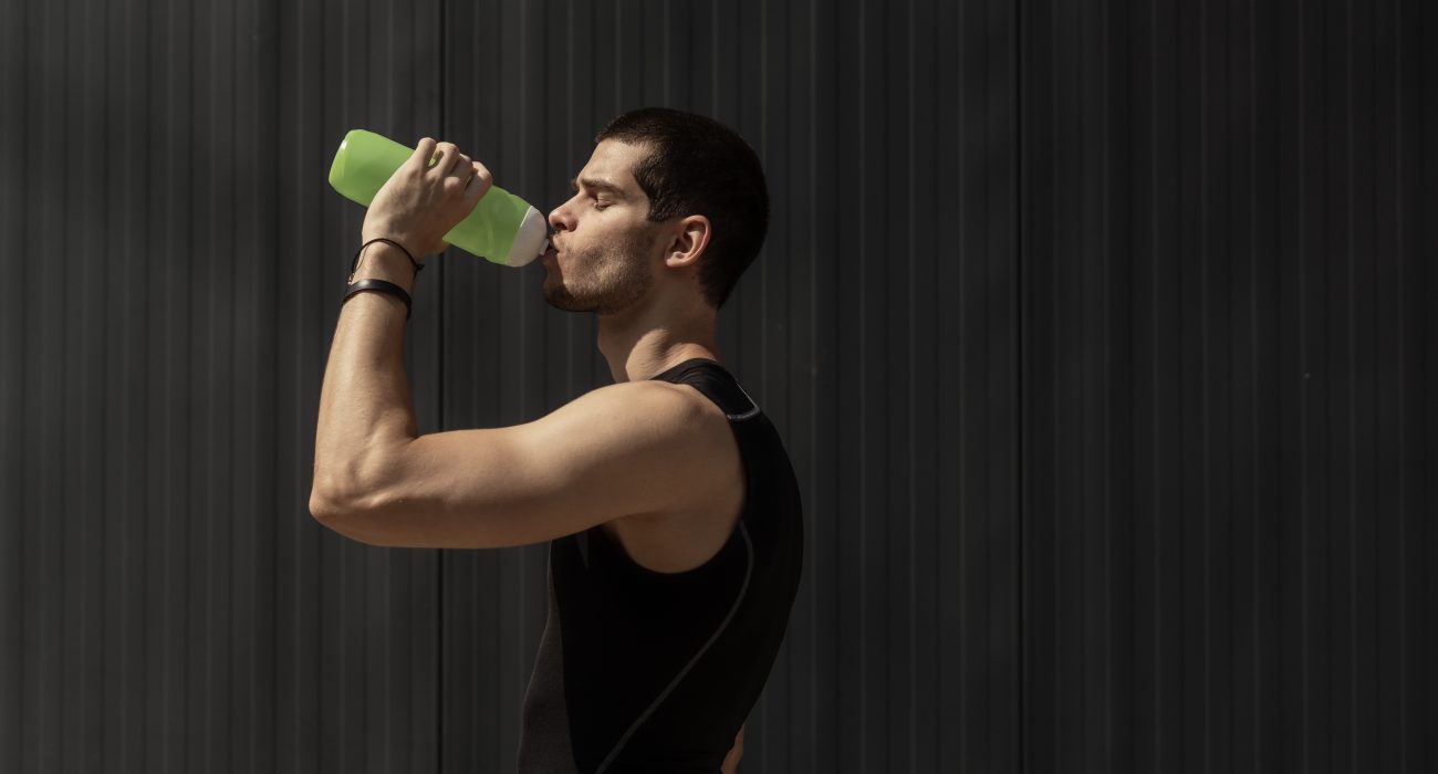 Muscular man stays fit and drinks water