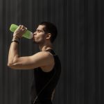 Muscular man stays fit and drinks water