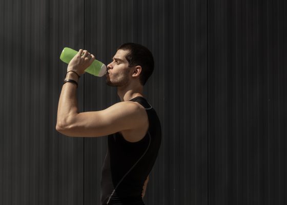 Muscular man stays fit and drinks water